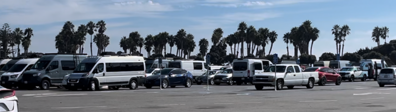 Parking lot full of vans at the Adventure Van Expo. 